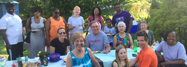 photo: people gathered around picnic table