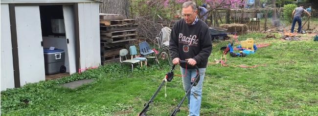 photo: man mowing grass