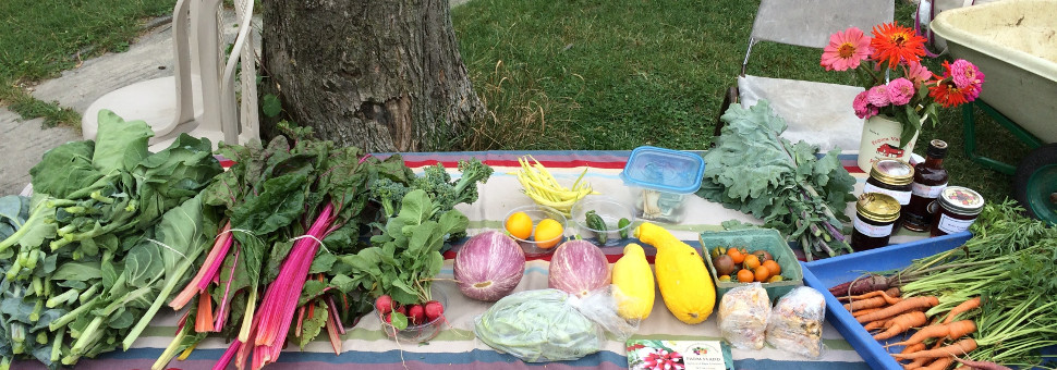 photo: table displaying fresh produce and flowers