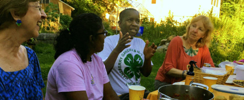 photo: women in animated conversation around picnic table