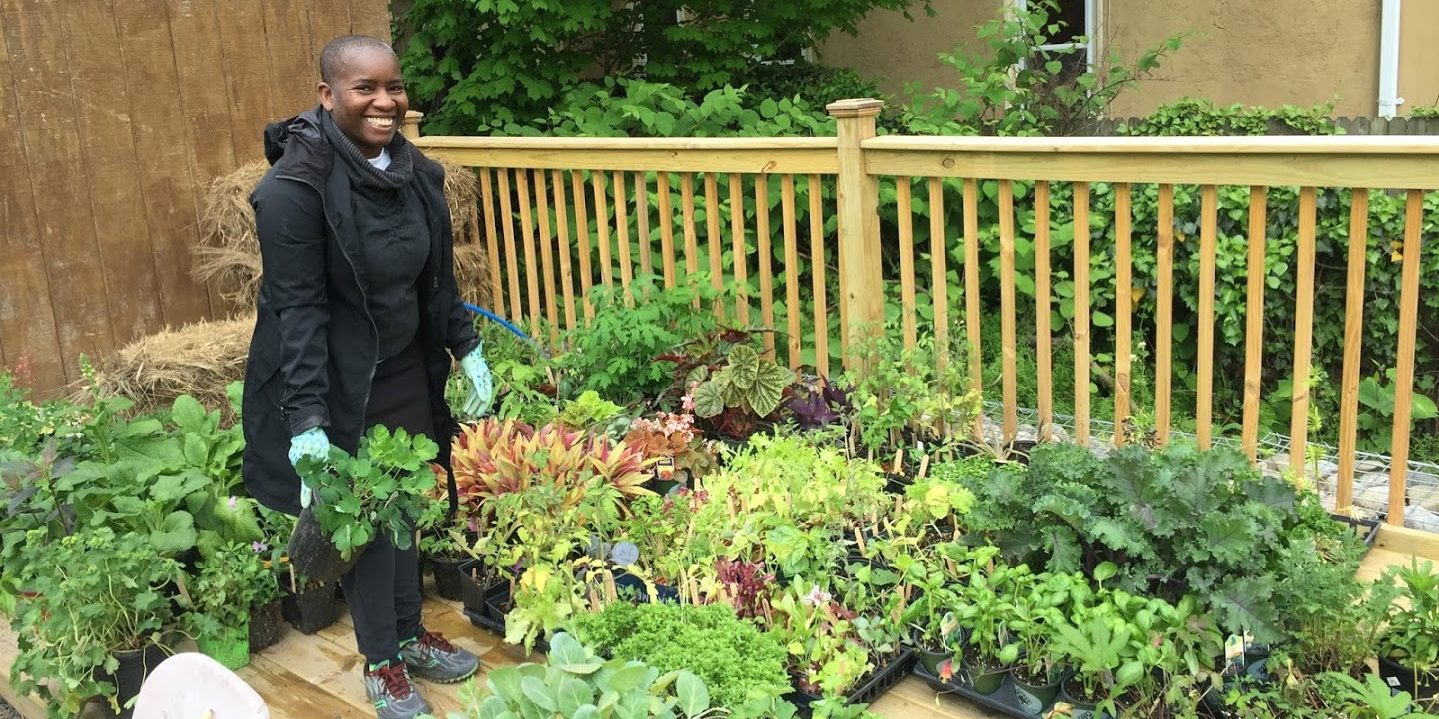 photo: smiling woman with hundreds of plants