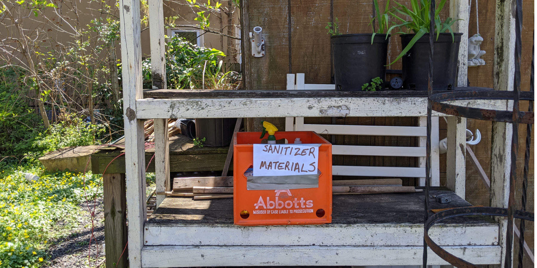 photo: shelf with crate of sanitizing supplies