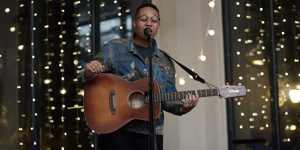 photo: performer with guitar at microphone