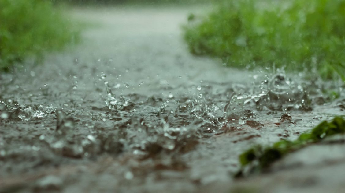 Photo: rain falling on sidewalk