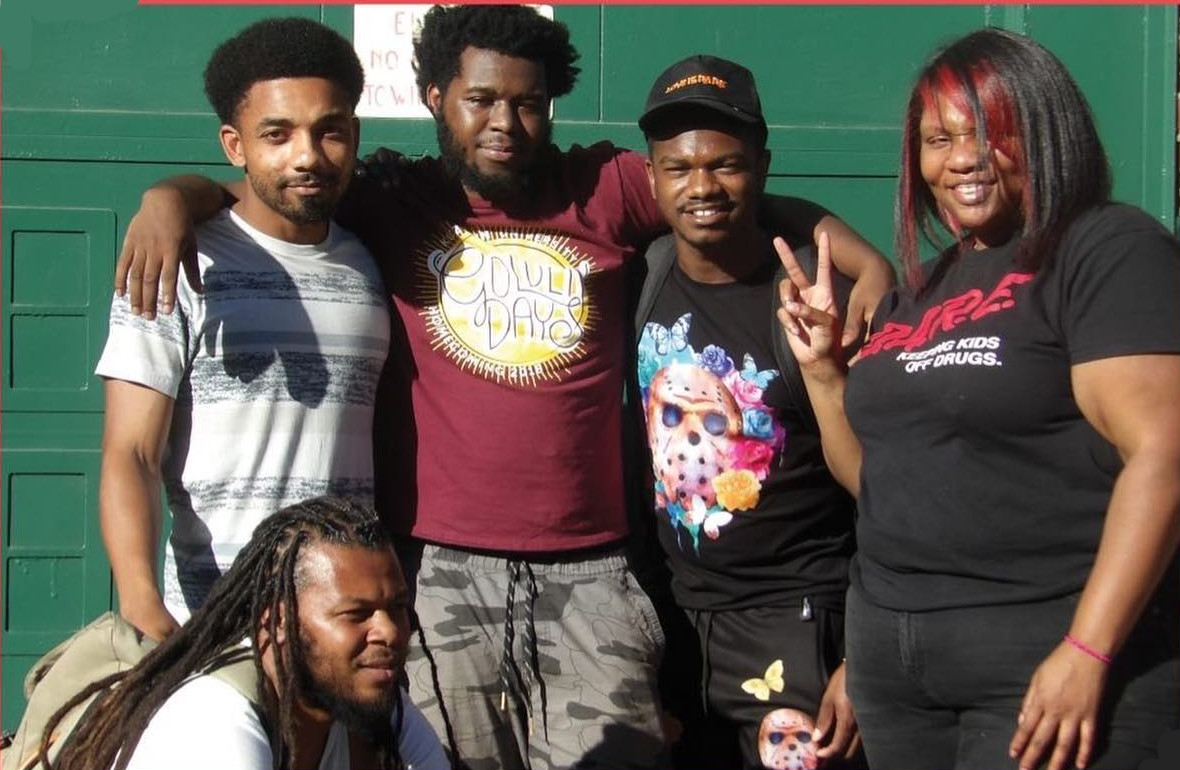 photo: group of four Black men and one Black woman